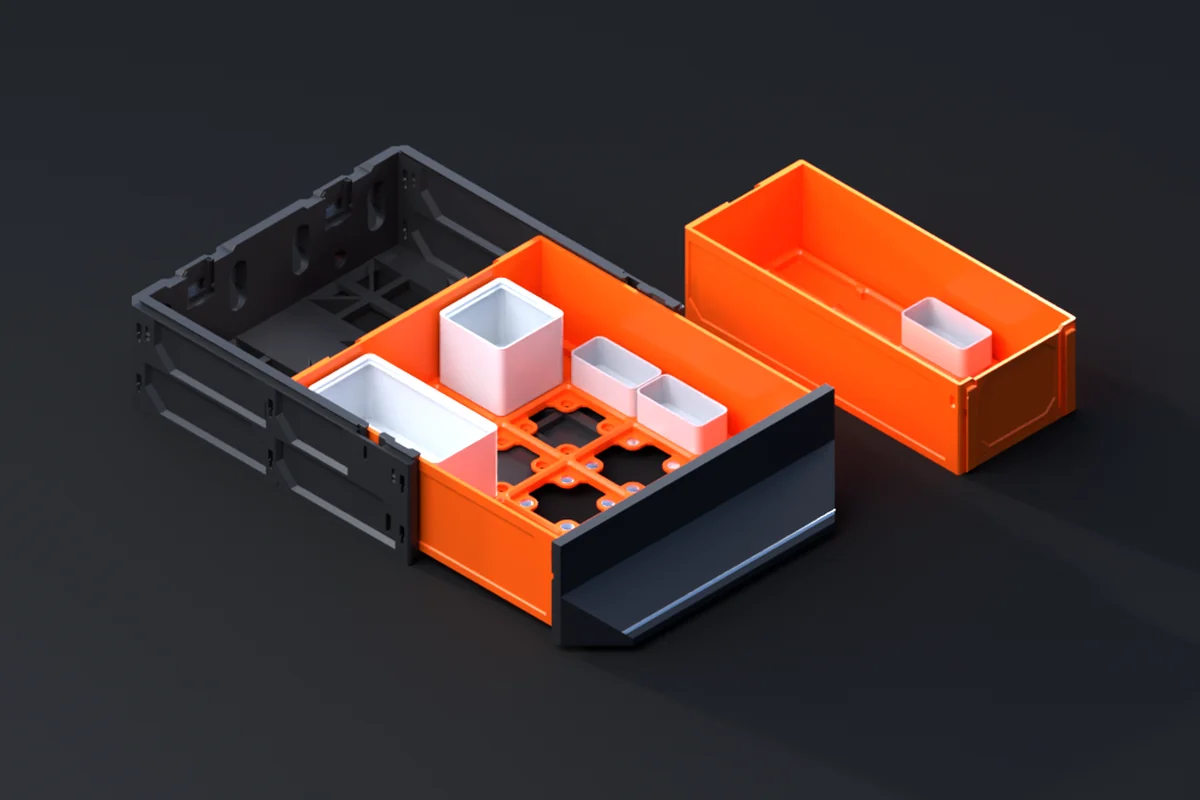 A Gridfinity Decor Drawer pulled out of its case, bins seated on the grid in its floor, a second drawer beside it