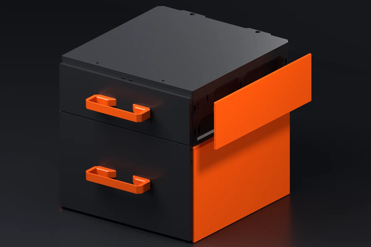 Two stacked black MODULITH cases with drawers: an orange side cover seated on the lower case's end wall, and a second one about to slide onto the case above