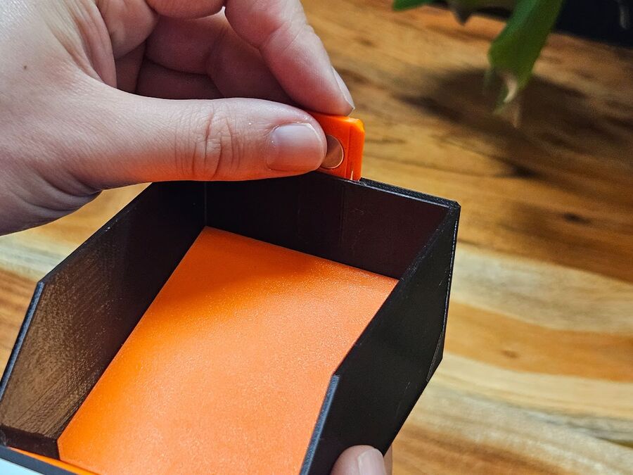 Pressing a magnet insert into the slot on a drawer body