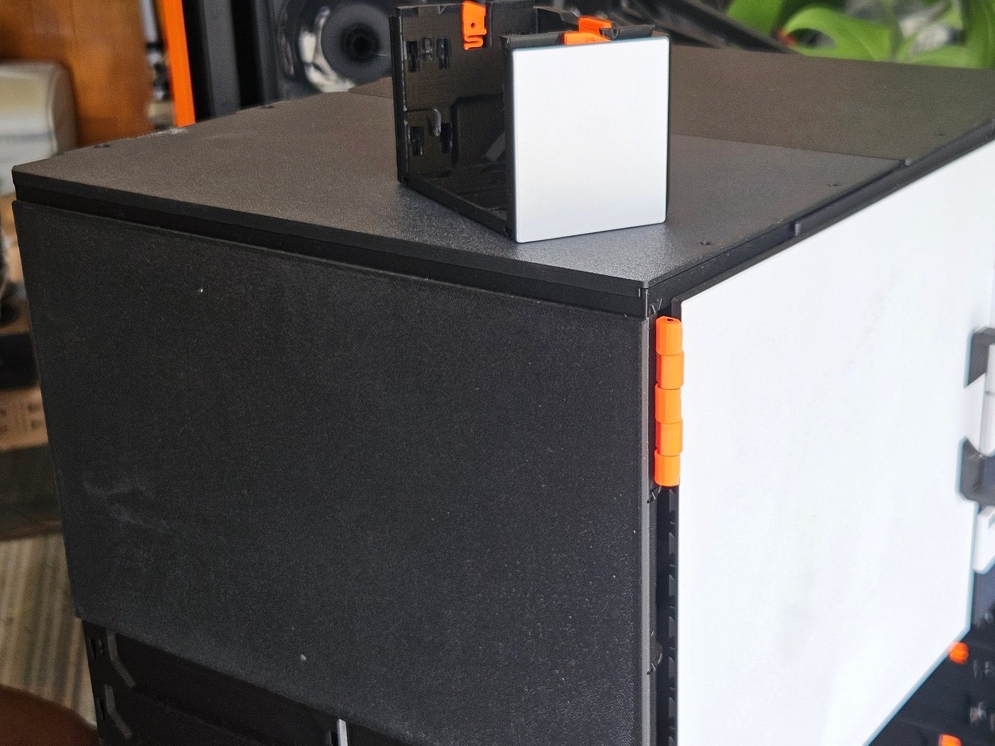 The corner of a black build: its end wall finished with a black side cover, and a small 59 case on top with a silver side cover